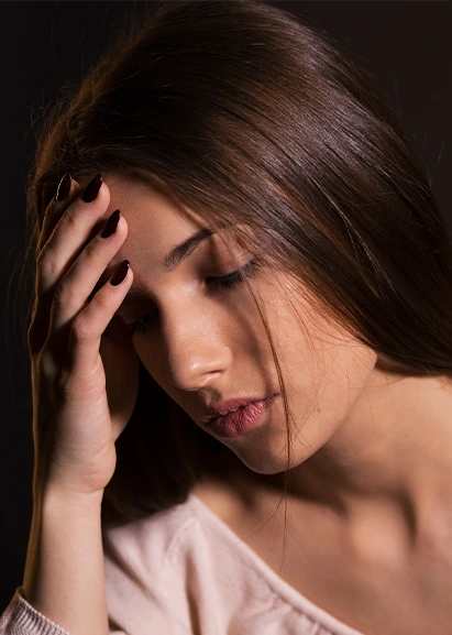 Woman in serious pain with a headache.